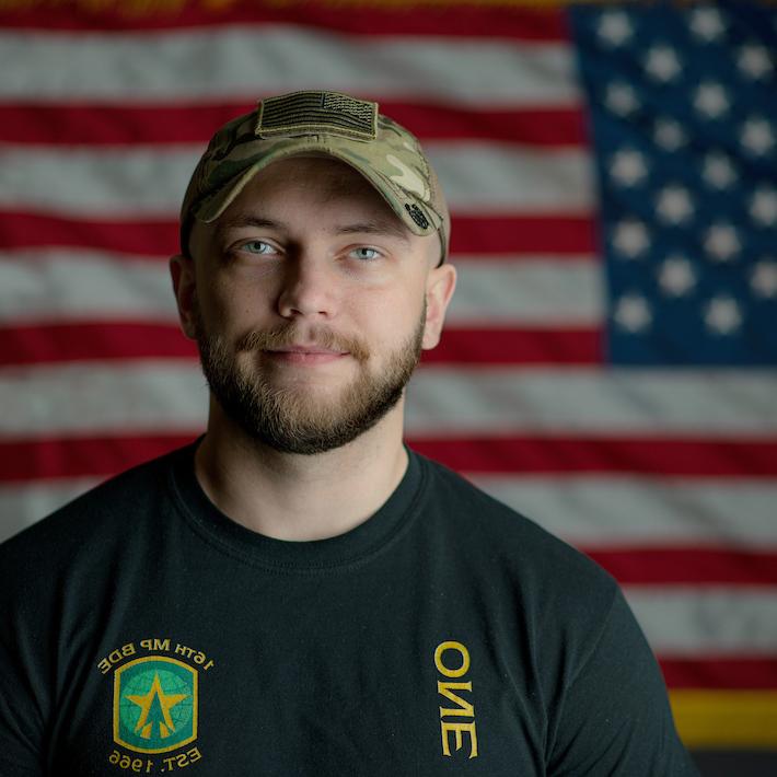 Headshot of an Ohio University veteran with a United States flag in the background