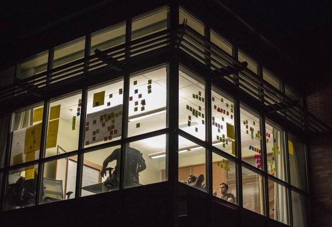 Innovation Center at night with post it notes on the windows